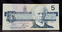 Front side of the 1986 Canadian $5 bill showing the portrait, denominations, and official markings.