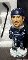 Front angle of Nic Hague bobble head showing uniform details and base