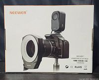 Front of the original box for Neewer USA Macro LED Ring Light Ring 48, showing product mounted on a Canon EOS 450D camera and displaying branding and product details.