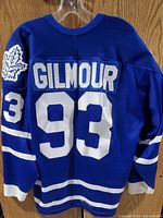 Back view of the blue Toronto Maple Leafs hockey jersey showing 'GILMOUR' name and '93' number in white.