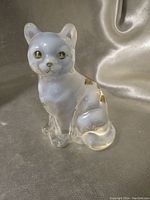 Clear opalescent glass cat figurine showing gold painted details and clear body.