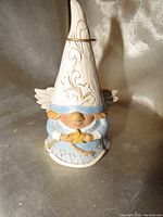 Front view of the Jim Shore Angel Gnome figurine showing the detailed facial features, wings, and star held in hands.