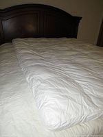 White Lucid mattress topper laid out on a bed showing full coverage and thickness