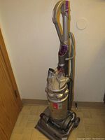 Full view of purple and silver Dyson FC-14 upright vacuum cleaner