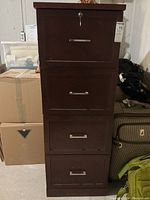 Front view of the filing cabinet showing all four drawers and lock on top drawer.