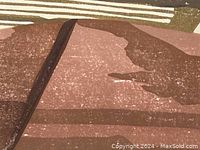 Close-up of print showing layered abstract hills in brown tones