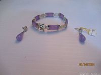 Photo showing the full set of one bracelet and matching earrings on a flat surface