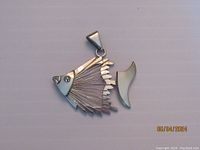 Front view of sterling silver angel fish pendant with detailed finwork and separate fin piece, pendant marked 925 Mexico on back