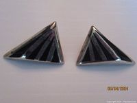 Front view of triangular sterling silver earrings with black onyx inlay in stepped pattern