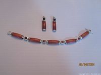 Full set showing bracelet with red jade links and square garnet stones along with matching earrings