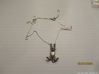 Full view of the sterling silver cat pendant necklace showing pendant and chain layout.