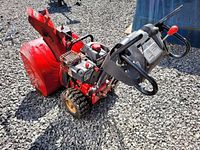 Side and rear views of the red Craftsman snowblower showing engine, controls, and auger housing.