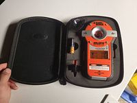Black & Decker Bulls Eye Auto-Leveling Laser tool in open black case, includes battery and small accessory holders