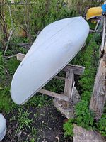 Overturned canoe on wooden support showing hull exterior