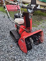 Front right view showing auger housing, discharge chute, engine