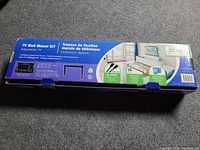 Blue box of TV wall mount kit showing model and adjustable tilt features, suitable for 37-45 inch TVs, includes HDMI cable and mounting hardware.