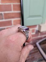 Side angle of 2001 World Series ring replica showing purple stones around the face and detailed engraving on side.