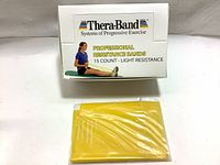 Box of Thera-Band professional resistance bands, 15 count, light resistance yellow color.
