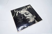 Photo of the album front cover showing the black and white close-up portrait of a woman with 'Geneviève' written across the top.