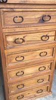 Front view of the pine highboy dresser showing six drawers with iron ring pulls.