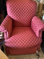 Front view showing the red upholstery with gold diamond pattern and cushioned arms.