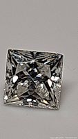 Top-down view of a square-shaped, princess cut moissanite showing clear, precise faceting and brilliance.