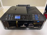 Front view of Canon MX420 printer showing power button, screen, and control buttons