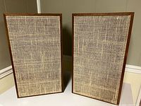 Front view of both speakers with original cloth grilles installed