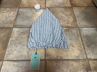 Full view of Lee Valley nightcap showing blue and white vertical stripes with white pom-pom at tip and original tag attached.