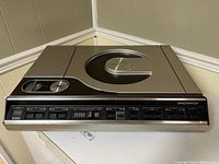 Front view of the Magnavox LaserDisc player showing the entire device with the top closed and control buttons visible on the front panel.