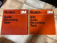 Two original Scotch 3M orange cardboard boxes for audio recording tape, labeled 'Audio Recording Tape' and '206 Audio Recording Tape'.