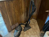 Full view of TriStar A101 canister vacuum cleaner with hose and power head attachment on carpeted floor.