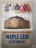 Front cover of the 1952-53 Toronto Maple Leafs Official Programme and Sports Magazine showing Maple Leaf Gardens building and NHL team pennants.