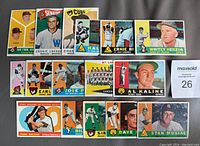 Top view of lot showing array of 16 vintage 1960 Topps baseball cards including Stan Musial, Whitey Herzog, Al Kaline, and others.