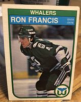 Front side showing Ron Francis in Whalers uniform skating on ice, card with green border and team logo
