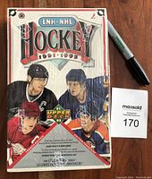 Front view of sealed 1991-92 Upper Deck Hockey card wax box in French edition with shrink wrap intact and visible Original Factory Seal.