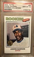 Front of 2003 Topps Andre Dawson card showing player image with Montreal Expos cap and Rookies banner, PSA graded 10 Gem Mint.