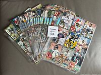 Wide view of the 225 football cards in clear plastic binder pages, showing colorful card fronts with various players and team logos.