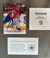 Front of Carey Price autographed 2008-09 Upper Deck hockey card showing player in goalie gear in action with blue Sharpie autograph.