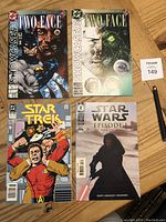 Photo showing all four comics: Two Two-Face comics (DC Showcase), Star Trek comic, and Star Wars Episode I comic.