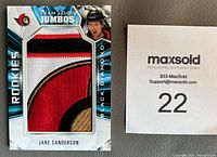 Front of Jake Sanderson rookie hockey patch card showing large sewn Ottawa Senators team logo patch and player photo