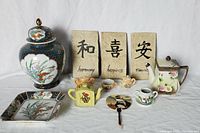 Full view of all items in the lot including ginger jar, teapot, child's tea set, plaques, and dish