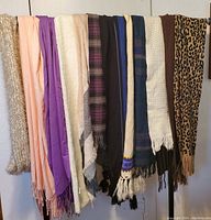 All scarves hung evenly to show assortment including colors and textures