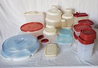 Photo showing assortment of plastic containers with various lid colors stacked and arranged