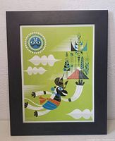 Framed artwork showing Hanuman flying with vibrant colors on green background, black frame, white mat.