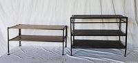 Two shoe racks side by side with metal frame and wood slat shelves on white fabric background.