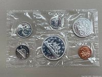 Front side of the 1963 Canadian prooflike coin set showing both obverse and reverse designs through sealed plastic.
