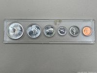 Front side of Canadian 1967 coin set showing reverse animal designs on coins in plastic holder