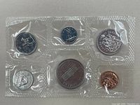 Six 1973 Canadian prooflike coins sealed in plastic with one side showing various denominations and designs.