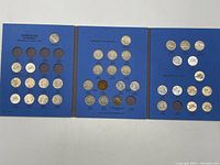 Three blue album pages displaying Canadian nickel coins with multiple slots, some empty, dated as early as 1922.